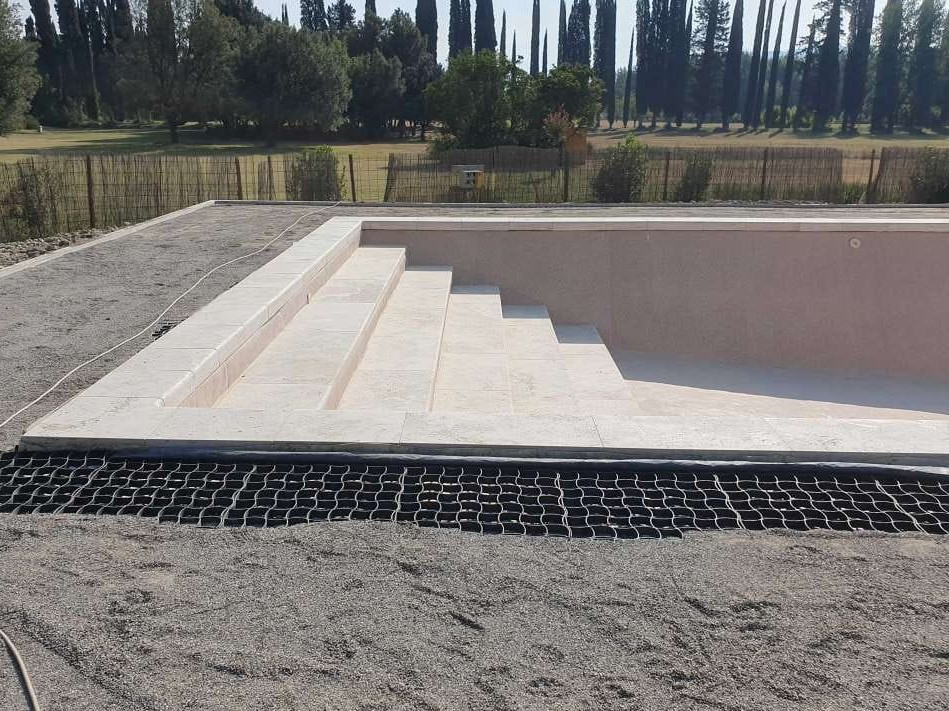 Organic pool built with travertine stone